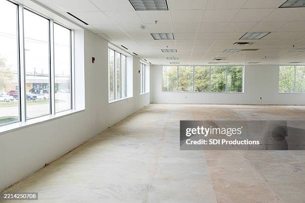 empty office space with large windows and copy space - unfurnished stock pictures, royalty-free photos & images