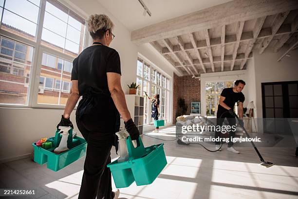 home cleaning crew in action - housework stock pictures, royalty-free photos & images