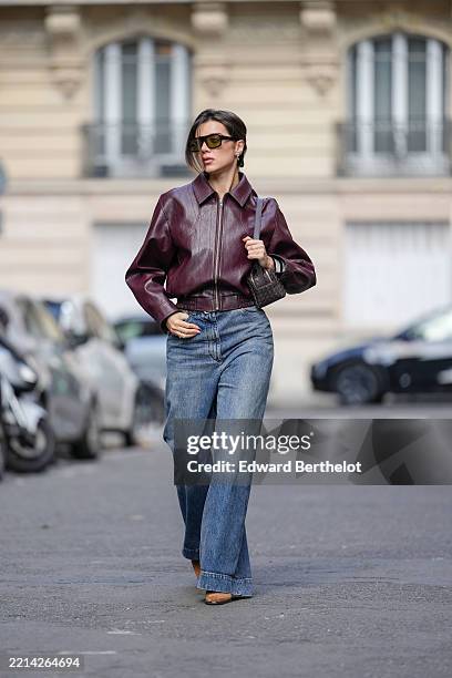 Katie Degas @katie.one wears dark brown hair tied back, dark lipstick and defined brows. Black aviator sunglasses by Vehla are styled with small gold...