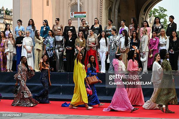 Contestants of the Miss World 2025 pageant pose in front of the Charminar during a heritage walk as part of the 72nd Miss World 2025, in Hyderabad on...