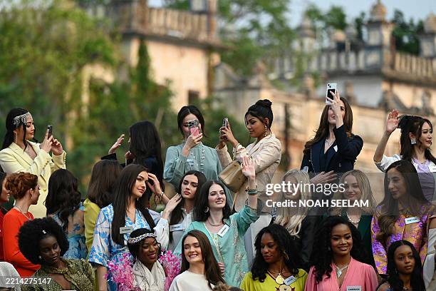 Contestants of the Miss World 2025 pageant pose in front of the Charminar during a heritage walk as part of the 72nd Miss World 2025, in Hyderabad on...