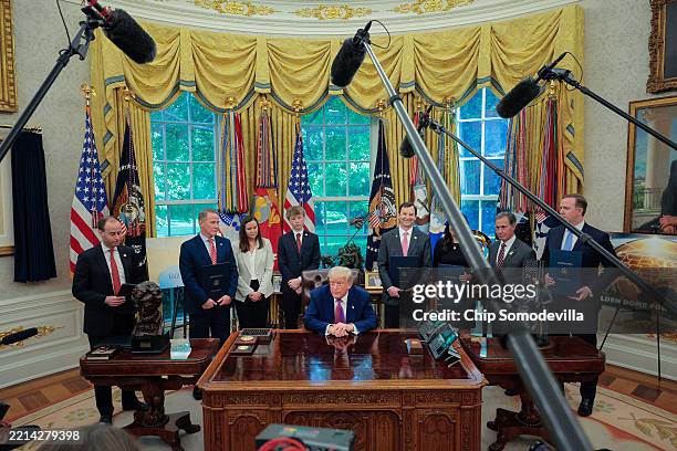 President Donald Trump is joined by White House staff secretary Will Scharf and Republican lawmakers Sen. Jon Husted , Sen. Ashley Moody , her son...