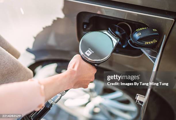 filling up diesel fuel at a gas station - energy crisis stock pictures, royalty-free photos & images