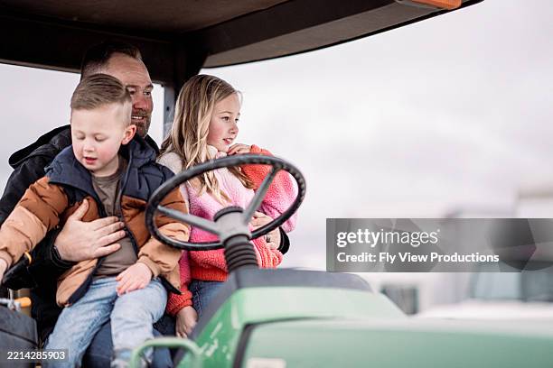 farmer with his kids at the farm - girl driving tractor stock pictures, royalty-free photos & images