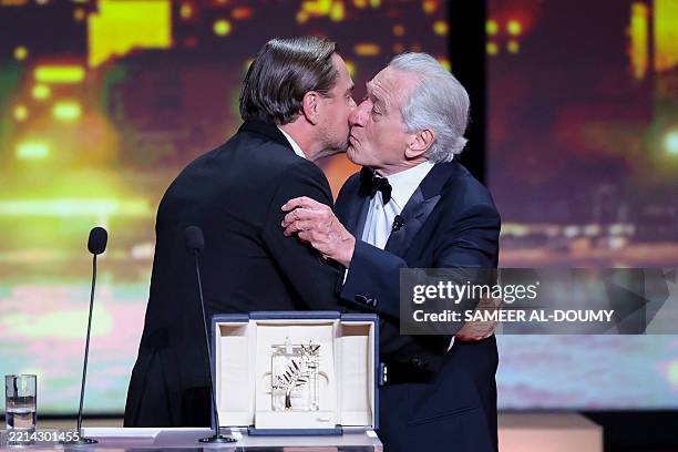 Actor Robert De Niro receives the Honorary Palme d'Or from US actor Leonardo Dicaprio during the Opening Ceremony of the 78th edition of the Cannes...