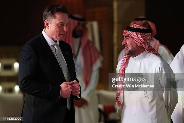 Elon Musk, Tesla CEO and Senior Advisor to the President of the United States talks with Yasir bin Othman Al-Rumayyan, governor of the Public...