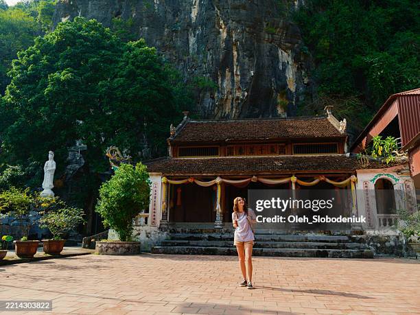 woman exploring hoa lu ancient capital during trip to vietnam - fossil free stock pictures, royalty-free photos & images