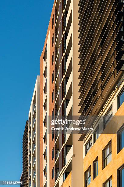 city apartment high rise building blue sky - saturated color stock pictures, royalty-free photos & images
