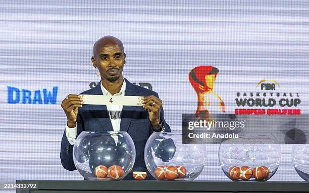 British athlete of Somali origin Sir Mo Farah holds a slip with the number 4 during the draw ceremony for the FIBA Basketball World Cup 2027...