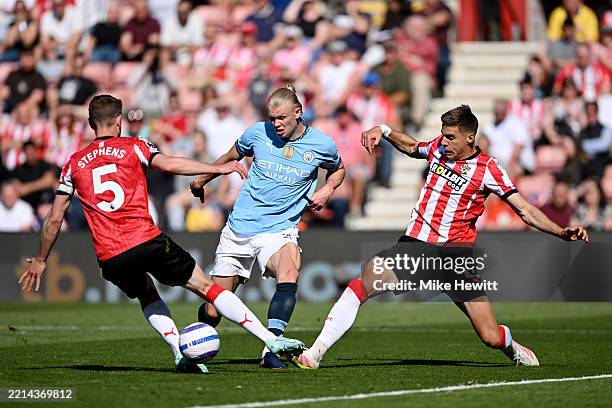 Erling Haaland of Manchester City is challenged by Jack Stephens and Jan Bednarek of Southampton during the Premier League match between Southampton...