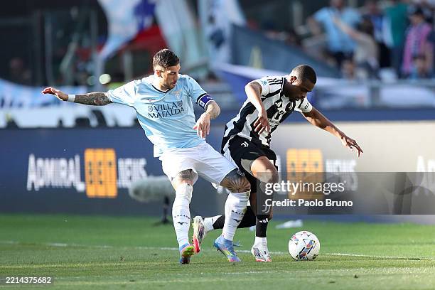 Mattia Zaccagni of Lazio battles for possession with Pierre Kalulu of Juventus during the Serie A match between SS Lazio and Juventus at Stadio...