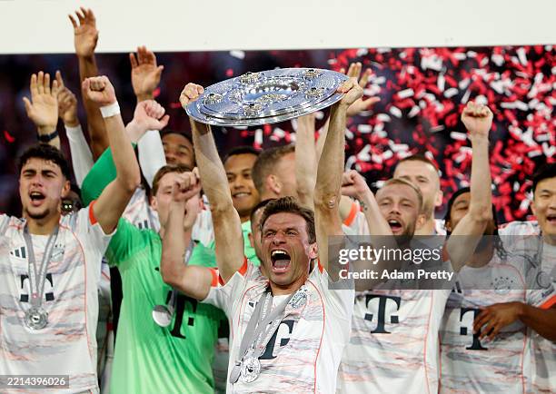 Thomas Mueller of Bayern Munich lifts the Meisterschale trophy, after the teams 2-0 victory in the Bundesliga match between FC Bayern München and...
