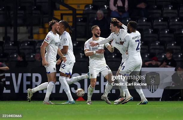 Riley Harbottle of AFC Wimbledon celebrates scoring his team's first goal with teammates during the Sky Bet League Two Play Off Semi Final First Leg...