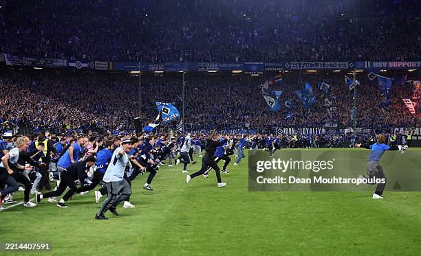 Fans of Hamburger SV invade the pitch following the teams victory and promotion to the Bundeslifa after the Second Bundesliga match between Hamburger...