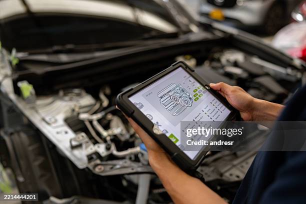 mechanic using a scanner to diagnose a problem with a car - ai car stock pictures, royalty-free photos & images