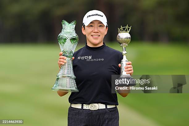 Jiyai Shin of South Korea poses with trophies after winning the tournament following the final round of World Ladies Championship Salonpas Cup at...