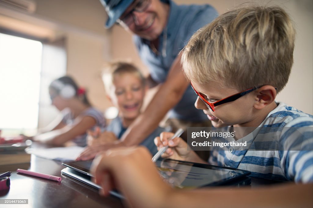 Father helping children to do homework in a bright study space at home.