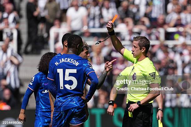 Referee, John Brooks shows a red card to Nicolas Jackson of Chelsea after clashing with Sven Botman of Newcastle United during the Premier League...