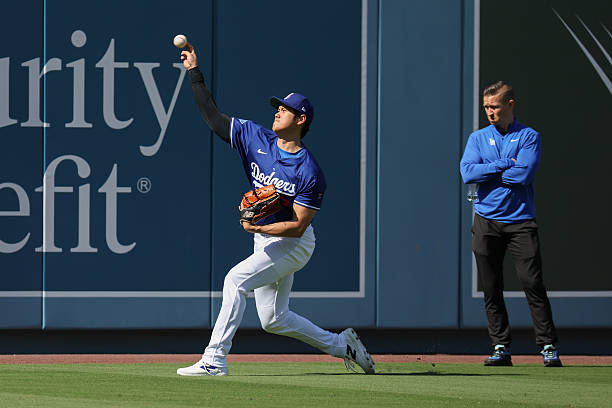 Shohei Ohtani of the Los Angeles Dodgers warms up in the outfield prior to the game between the Athletics and the Los Angeles Dodgers at Dodger...