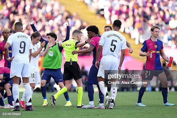 Players of FC Barcelona react, as referee Alejandro Jose Hernandez Hernandez gestures no penalty following a VAR review during the LaLiga match...