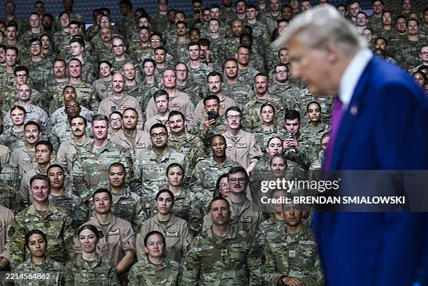 President Donald Trump arrives to address troops at the Al-Udeid air base southwest of Doha on May 15, 2025.