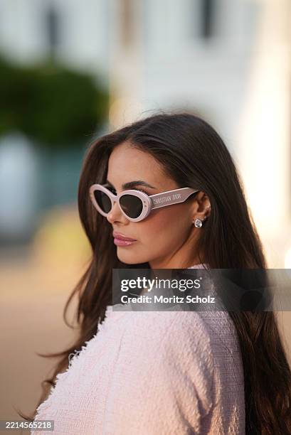 Shanice Messina is seen wearing a pink bouclé box jacket from Zara, a pair of leather moccasins in ivory with golden logo detail from Chanel, oval...