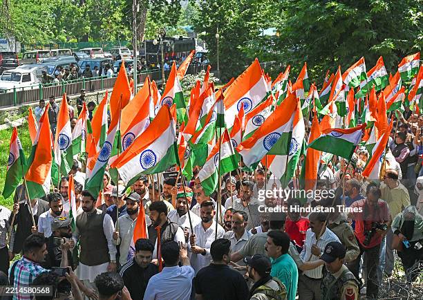 Supporters of Bharatiya Janata Party hold country's national flags as they take part in a Tiranga rally to honor Armed forces on May 15, 2025 in...