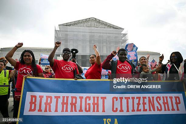 People hold a banner as they participate in a protest outside the US Supreme Court over President Donald Trump's move to end birthright citizenship...