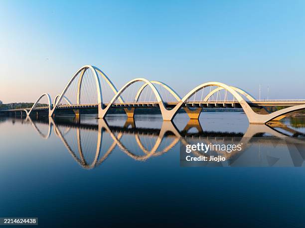 modern bridge at sunset - symmetrie stock-fotos und bilder