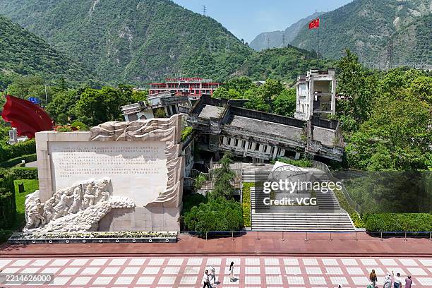 Visitors pay tribute to victims at the ruins of Xuankou Middle School, now a memorial site for the 2008 Wenchuan earthquake, on May 11, 2025 in...