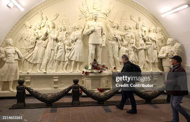 Men put flowers at a new monument to former Soviet leader Joseph Stalin at Taganskaya Metro station, May 15, 2025 in Moscow, Russia. A monument to...