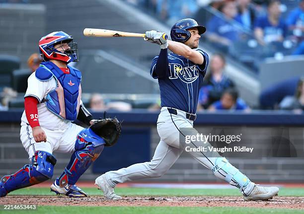 Brandon Lowe of the Tampa Bay Rays hits his second 2-run home run of the game in the ninth inning during a game against the Toronto Blue Jays at...