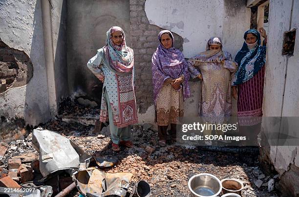 Indian women villagers inspect their house damaged in cross-border shelling in Uri, a town near the Line of Control . Last week, nuclear-armed...