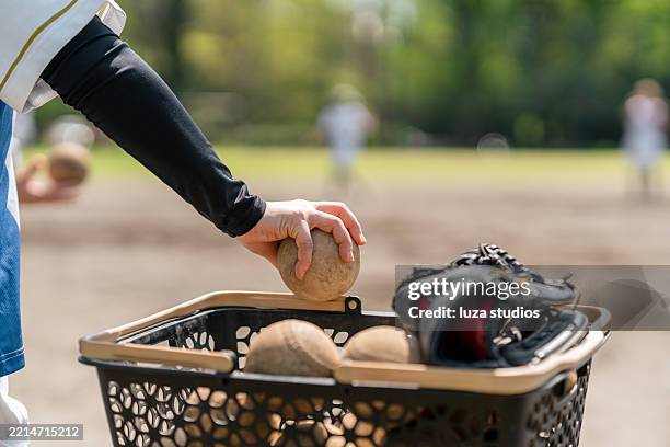softball practice equipment on the field with focus on glove and ball - sports glove stock pictures, royalty-free photos & images