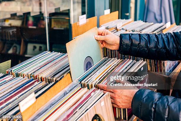 man choosing vinyl records at the record shop, close-up - schallplatte stock-fotos und bilder