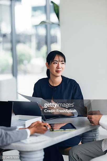 businesswoman participating in professional meeting with laptops and documents - delegating stock pictures, royalty-free photos & images