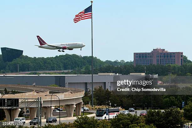 An Omni Air International charter flight from South Africa to the United States lands at Washington Dulles International Airport on May 12, 2025 in...