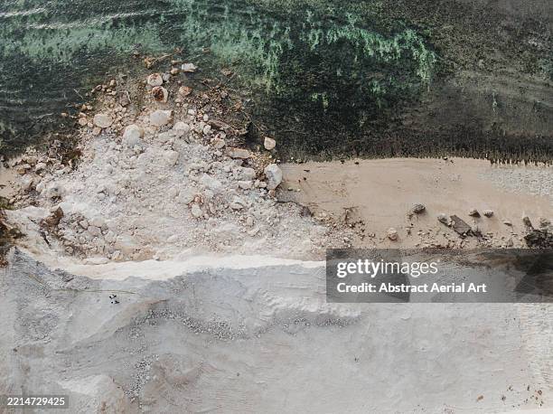 landslide covering a beach caused during the excavation of coastal limestone cliffs photographed from a drone point of view, uluwatu, bali, indonesia - calcário rocha sedimentar imagens e fotografias de stock