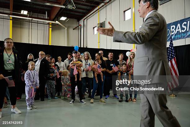 Newly arrived South Africans are welcomed by U.S. Deputy Secretary of State Christopher Landau in a hangar at Atlantic Aviation Dulles near...