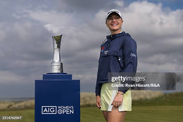 Charley Hull poses for a photograph with the AIG Women's Open Trophy on the Practice Green at Royal Porthcawl Golf Club on May 12, 2025 in Bridgend,...