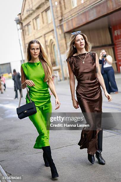Isabel Lucas wearing green satin dress and black boots during the Australian Fashion Week 2025 on May 13, 2025 in Sydney, Australia.
