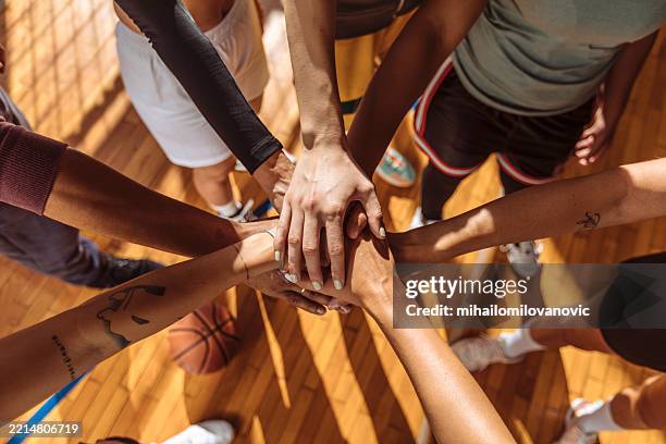 close up of basketball team stacking hands - hand stack stock pictures, royalty-free photos & images