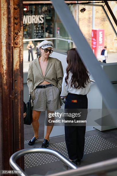 Guest wearing khaki blazer, grey short and black shoes during Australian Fashion Week 2025 on May 13, 2025 in Sydney, Australia.