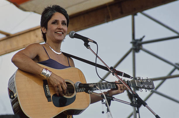 American singer-songwriter playing her acoustic guitar during a performance, 1986.