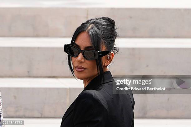 Kim Kardashian arrives at the Palais de Justice, wearing Alaia sunglasses, on May 13, 2025 in Paris, France.
