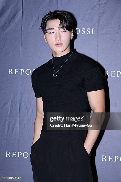 San of boy band ATEEZ, jewelry detail, poses for a photocall for REPOSSI flagship store opening at Hyundai Department Store on May 13, 2025 in...