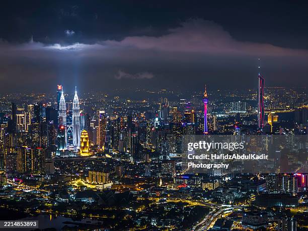 kuala lumpur skyline at evening: a vibrant urban tapestry - malaysia city skyline stock pictures, royalty-free photos & images