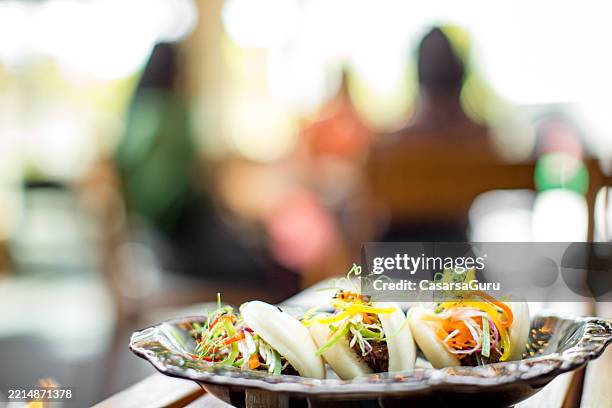 bao buns serving size on table - fusion food stock pictures, royalty-free photos & images
