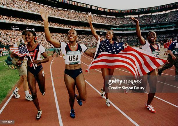 The USA 4x100 relay team, Gwen Torrance, Inger Miller, Gail Devers and Christy Gains celebrate after winning the gold medal during the 1996...