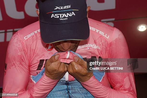 Astana Team's Italian rider Diego Ulissi celebrates the Pink jersey of the overall leader on the podium after the 8th stage of the 108th Giro...